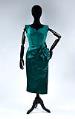 Image of Emerald green cocktail dress with large flower on left hip, ca. 1950